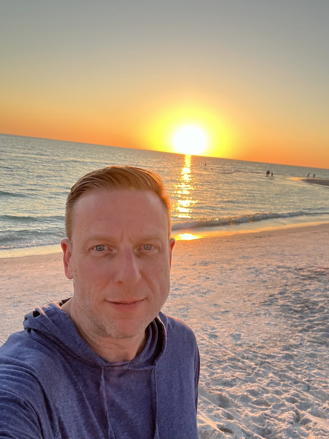 Peter J. Johnson on a beach at sunset